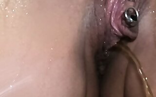 I film just about close_up on the pierced clitoris, and on the heavy pussy of a magnificent milf pissing standing nigh just about the shower
